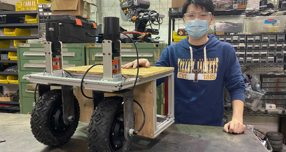 A member poses with the completed Swervi test rig
